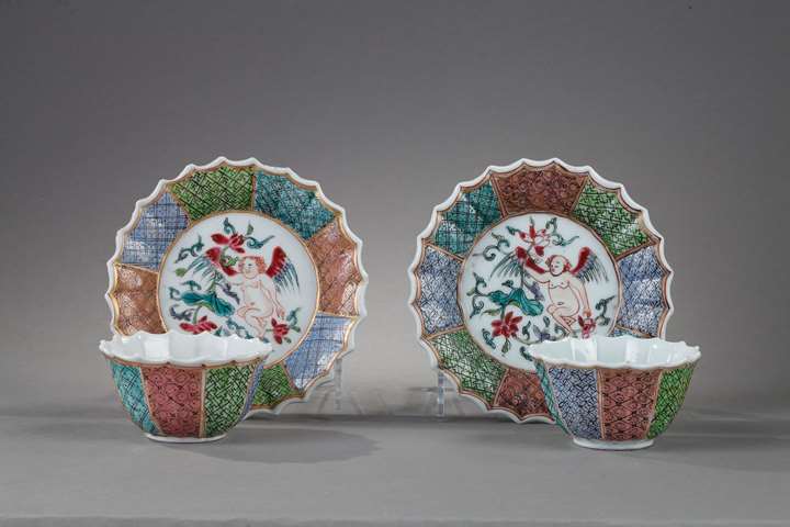 Pair cups and saucers Famille rose porcelain decorated with a putto holding a lotus flower